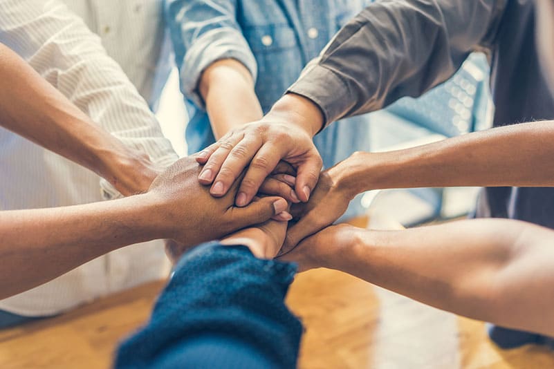 Group of people connecting hands