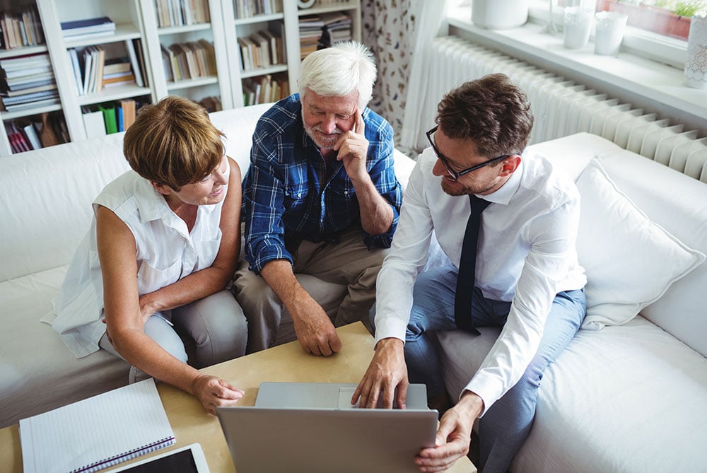 Financial Advisor Helping Elderly Couple with Finance Information